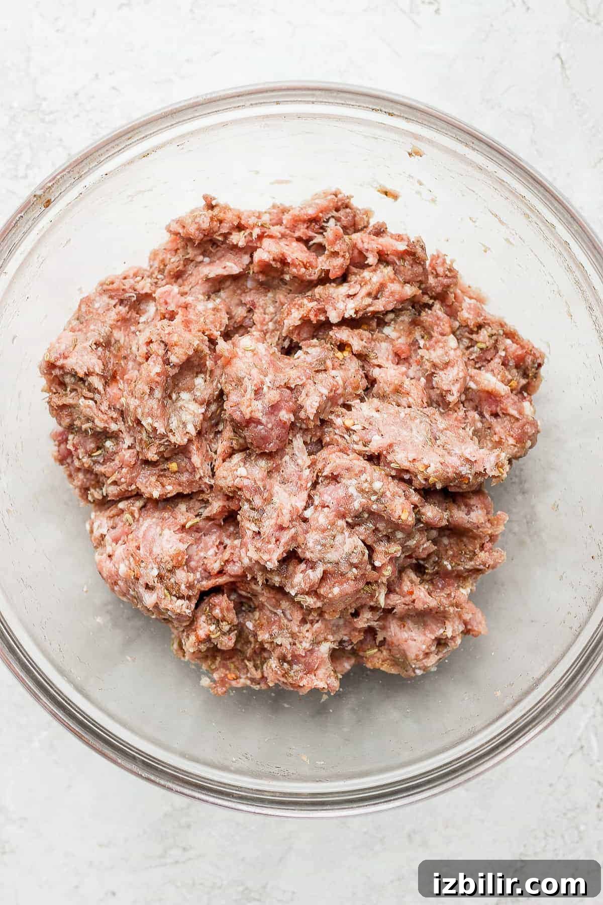 Mixing meat and spices meat in bowl