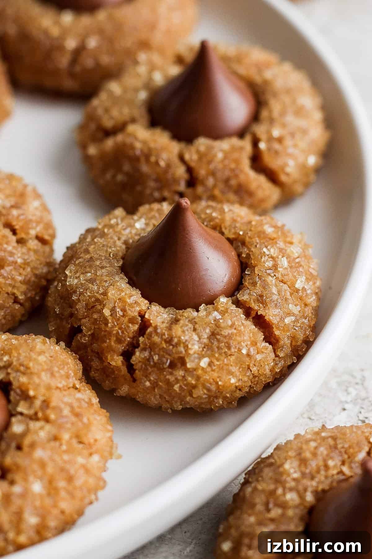 Peanut butter cookies with chocolate kisses on a plate.