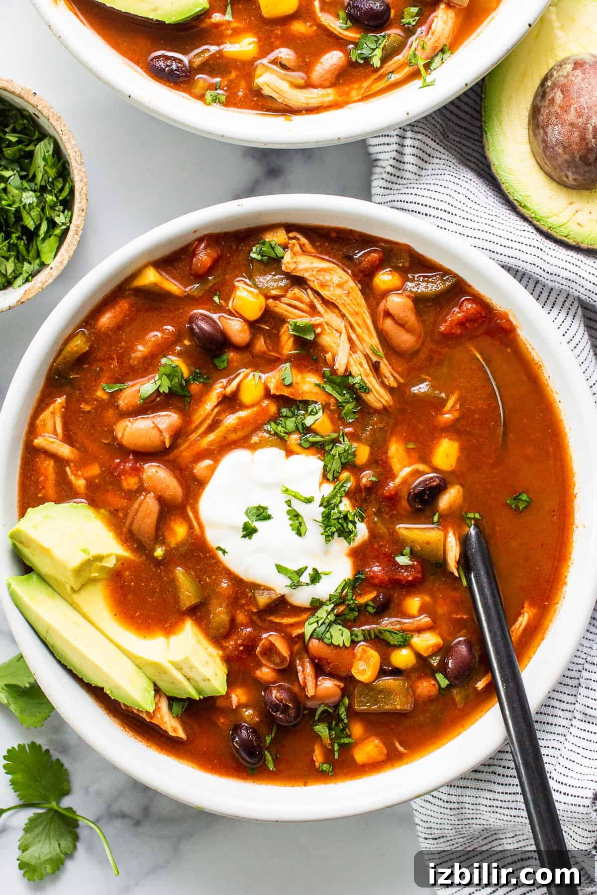 Crockpot Chicken Enchilada Soup Recipe 2 Bowl of chicken enchilada soup with avocado and sour cream