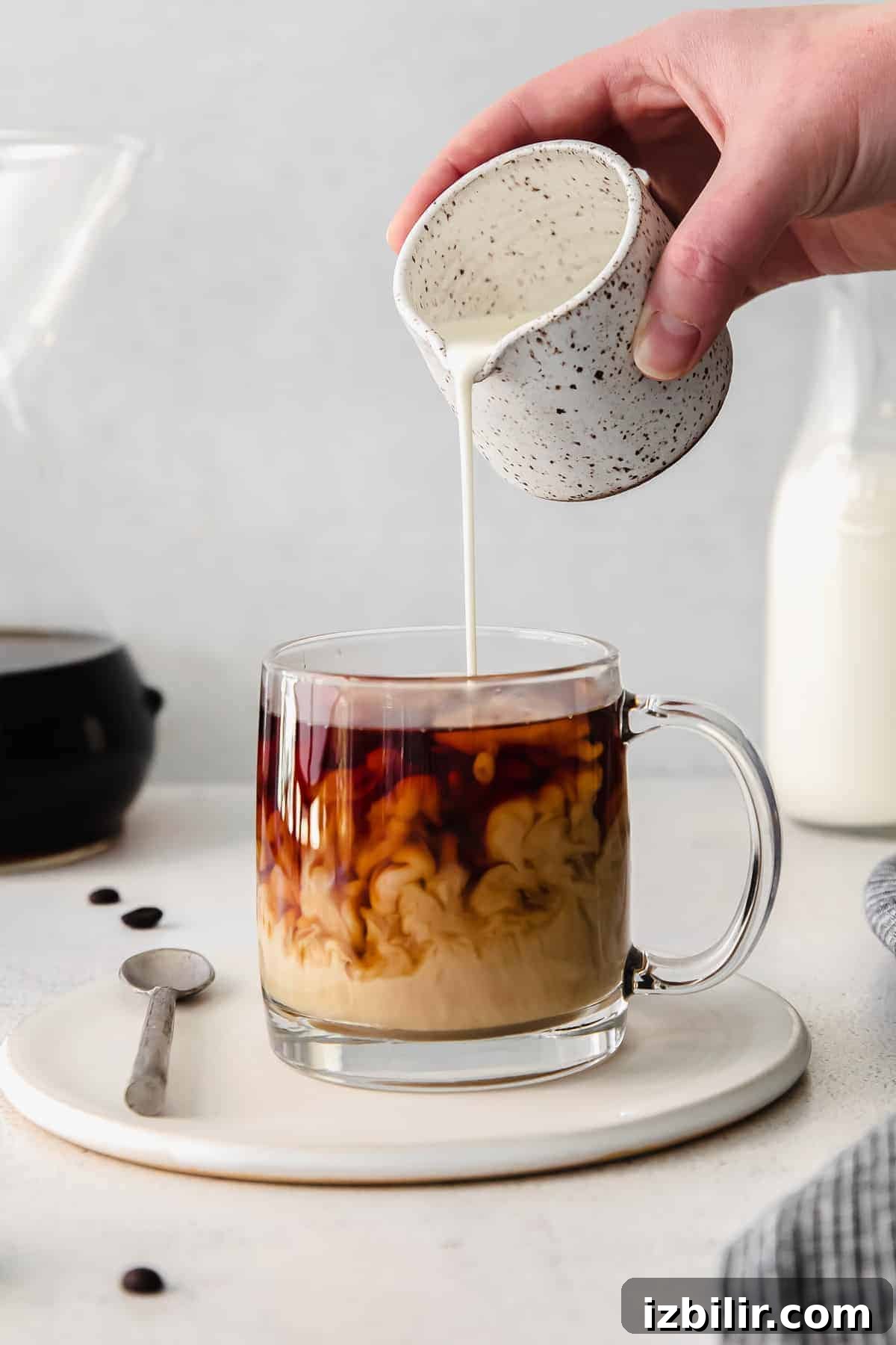pouring cream into coffee