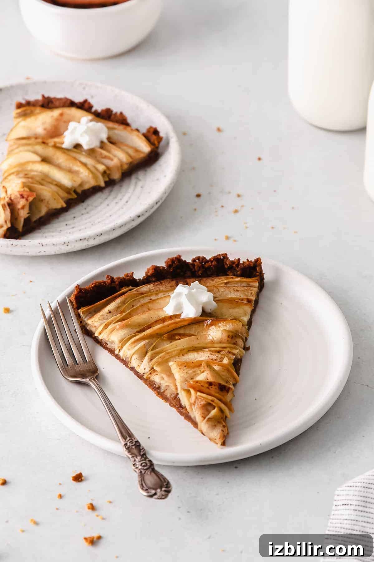 Classic French Apple Tart with Caramelized Apples 9 A piece of apple tart on a plate.