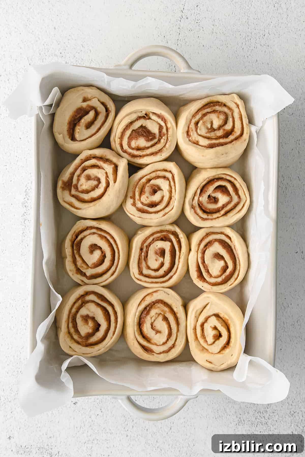 maple cinnamon rolls in a casserole dish ready to be baked