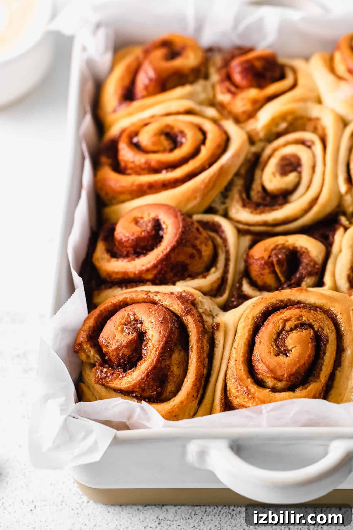 maple cinnamon rolls after being baked looking fluffy and amazing