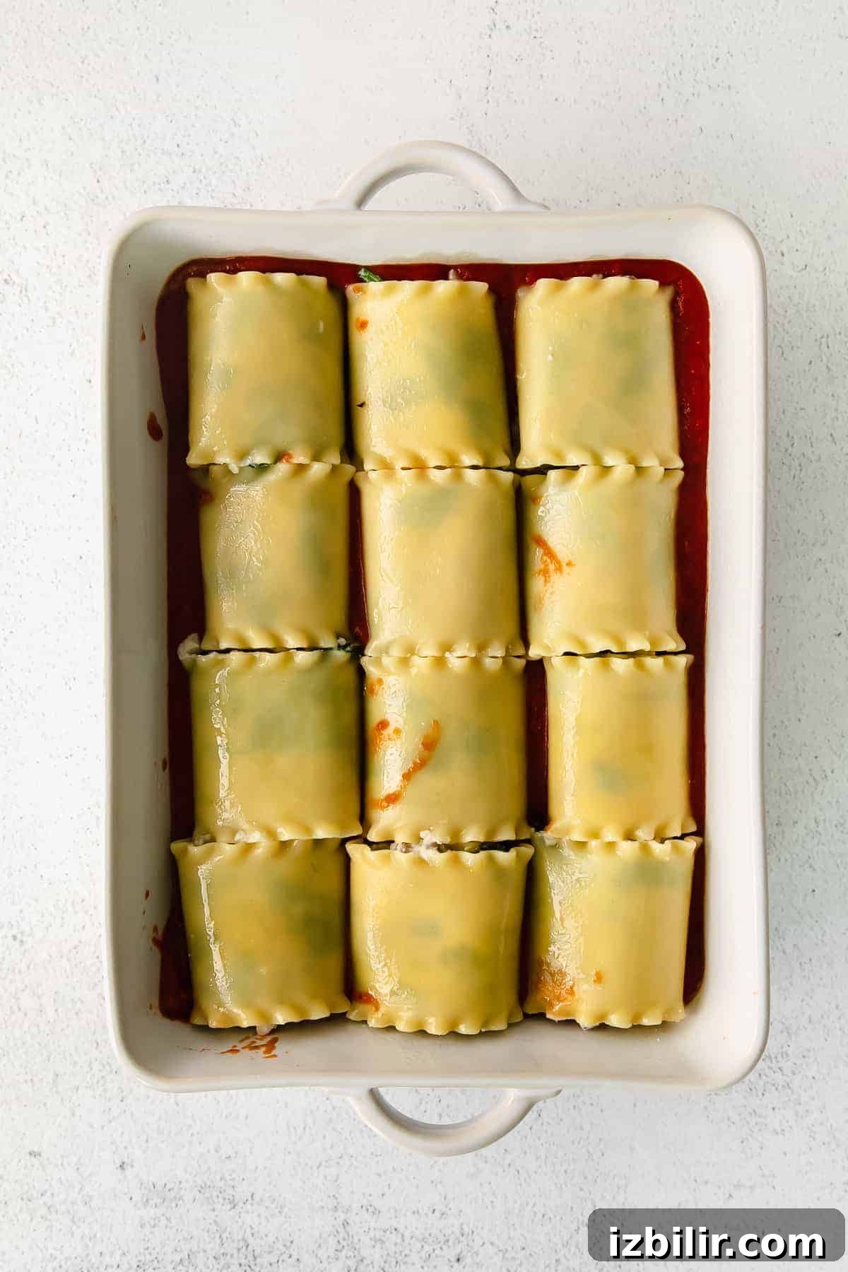 Classic Lasagna Roll-Ups Recipe 7 Lasagna roll ups in a casserole dish.