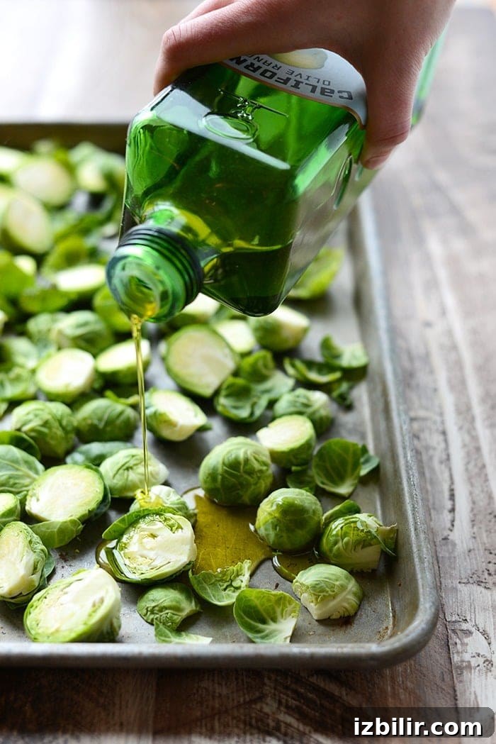 Roasted Brussels Sprouts with Balsamic Glaze 3 brussel sprouts being drizzled with olive oil