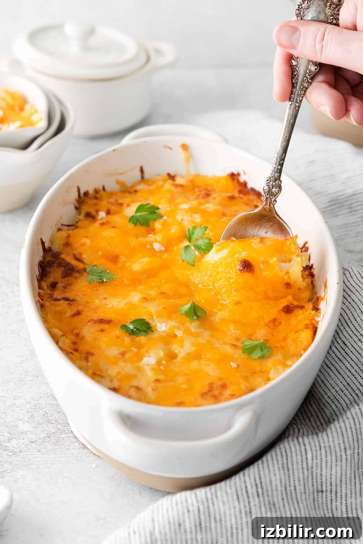 Hash browns mixed with cheese in a baking dish hash browns in casserole dish