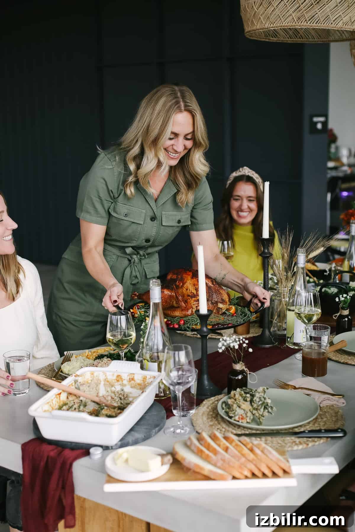 Thanksgiving Menu 2021: Your Complete Holiday Recipe Guide 2 woman placing turkey on a thanksgiving table