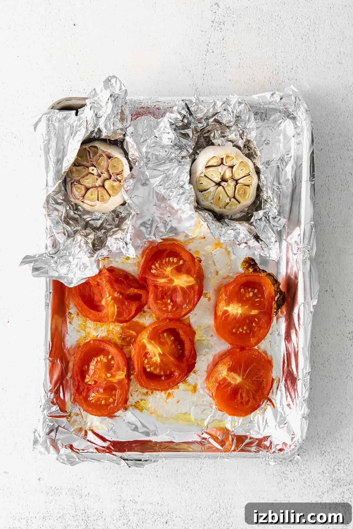 roasted tomatoes and garlic on sheet pan