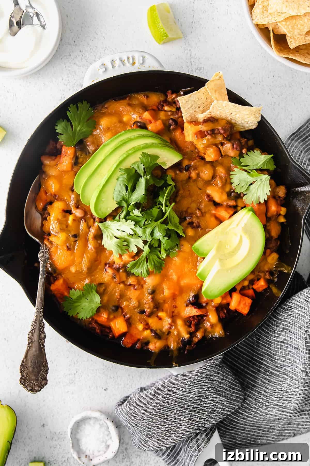 turkey sweet potato enchilada skillet topped with fresh avocado and cilantro