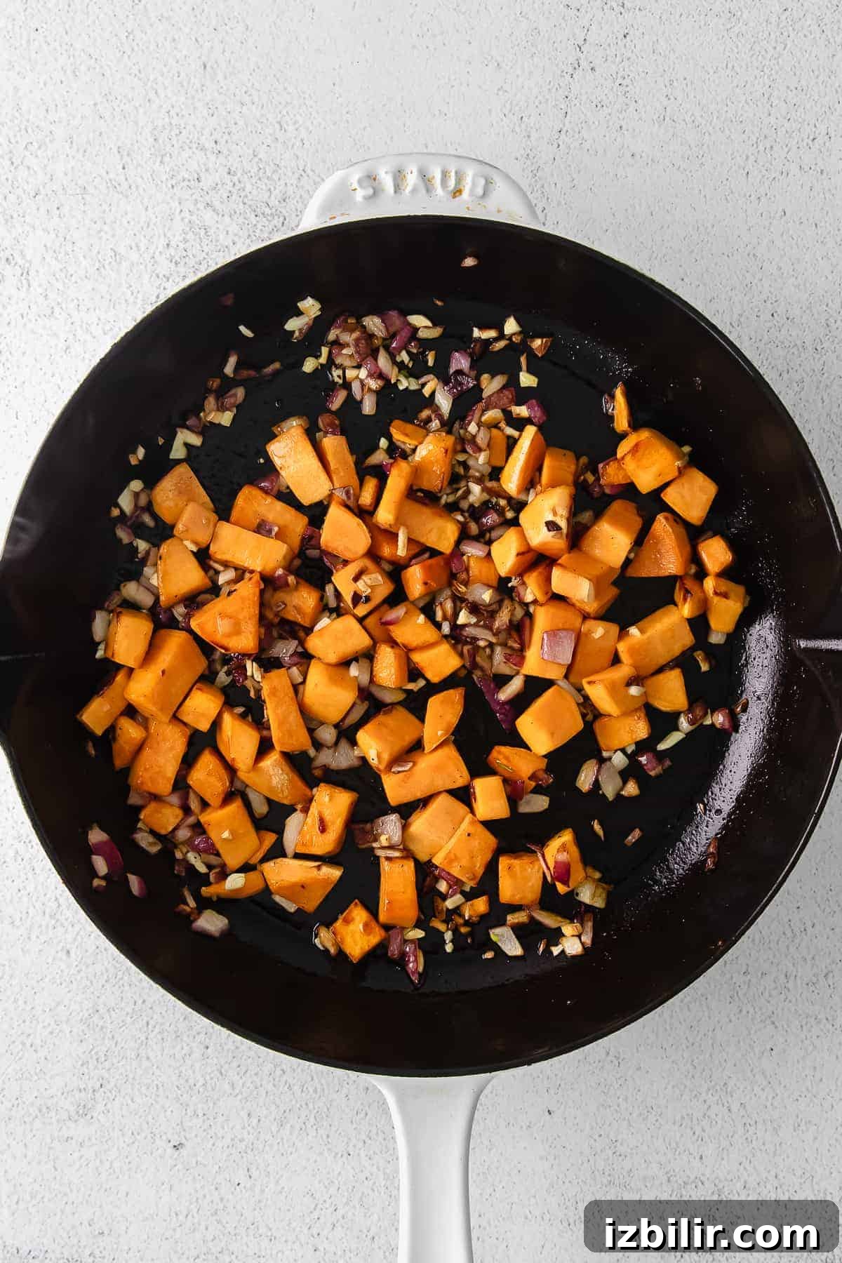 diced sweet potatoes in a cast iron skillet