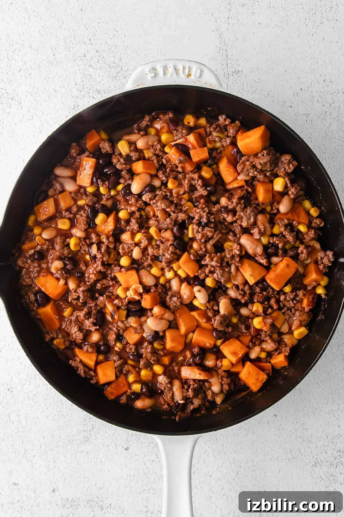 enchilada skillet ingredients in a cast iron skillet