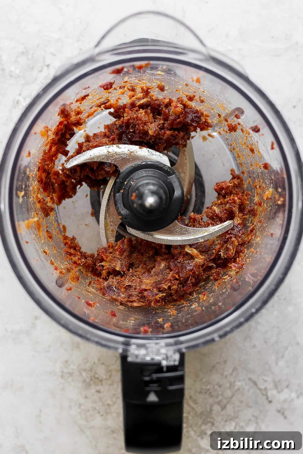 No-Bake Salted Caramel Date Cups Recipe 3 A food processor filled with a blended date mixture.