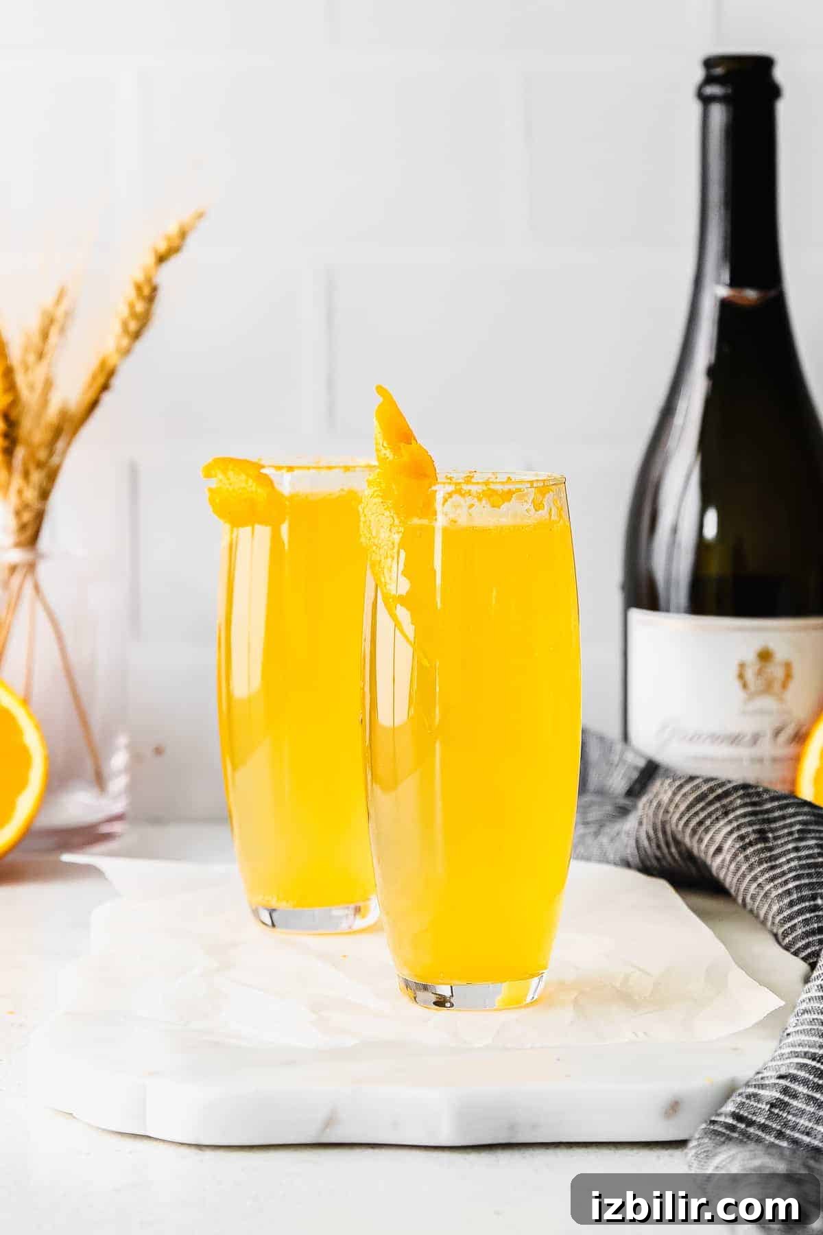 Simple Mimosa Recipe two mimosas in stemless champagne flutes