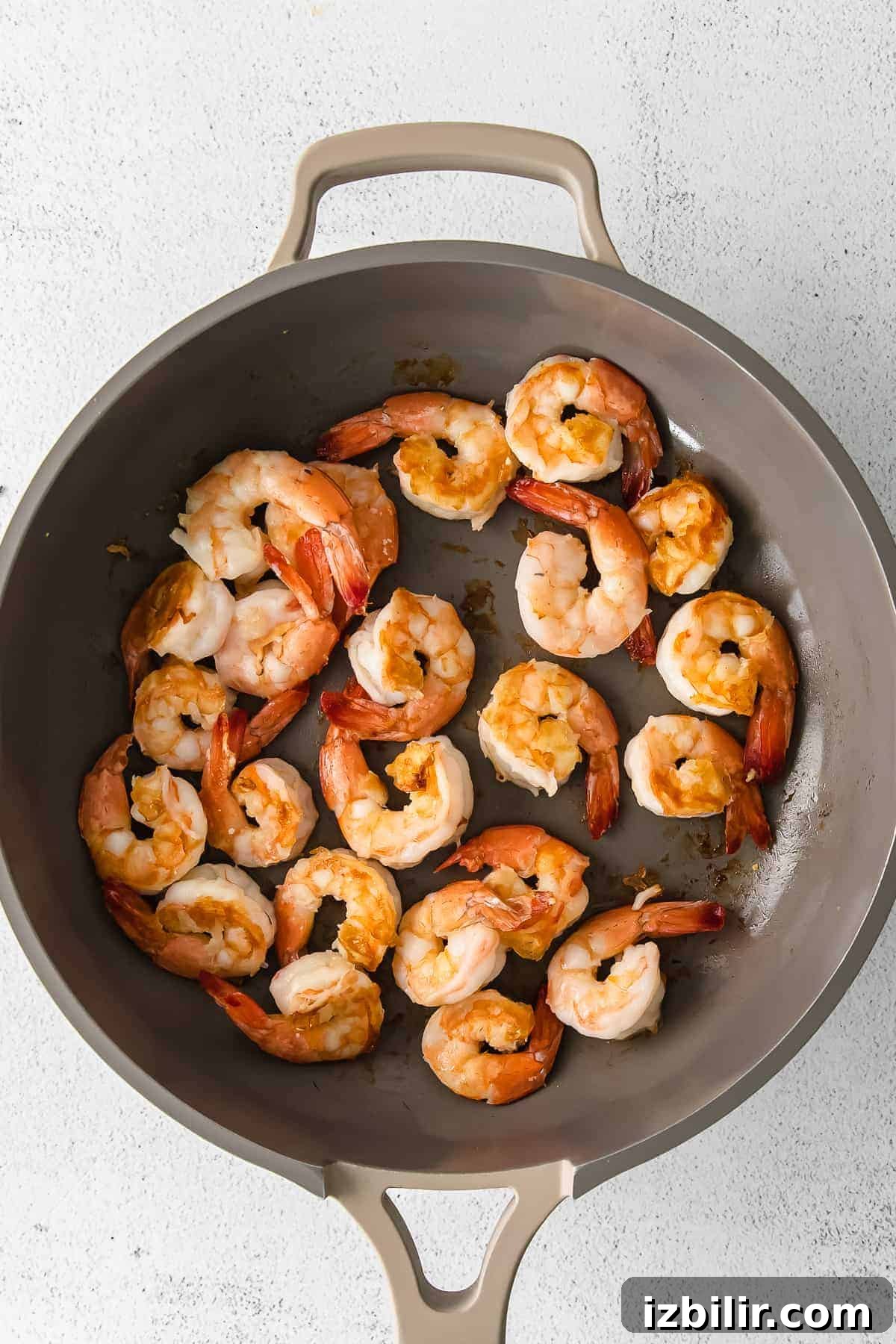 Garlic Butter Sauteed Shrimp with Lemon 5 Cooked shrimp in a pan.