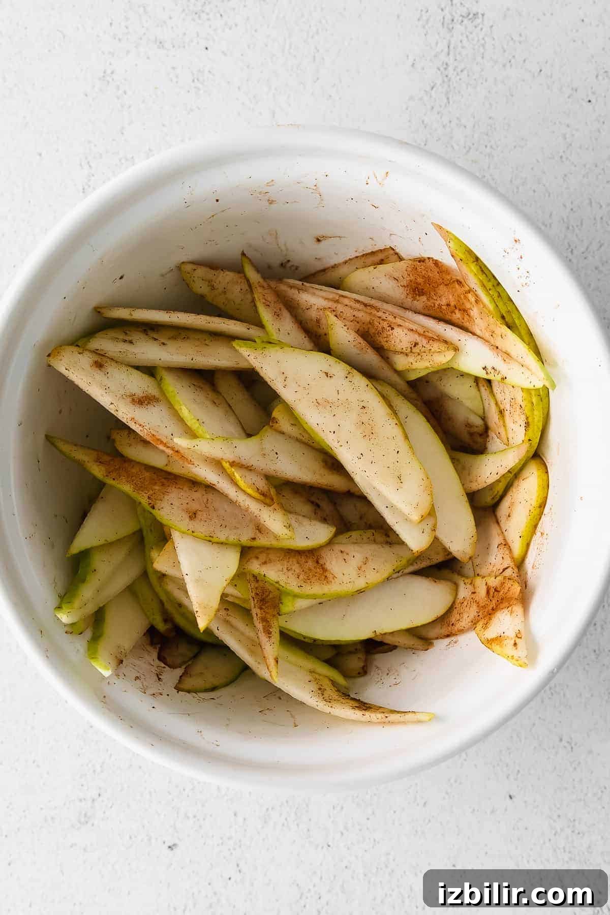 Rustic Honey Pear Galette Recipe 5 Pears and spices in a large bowl.