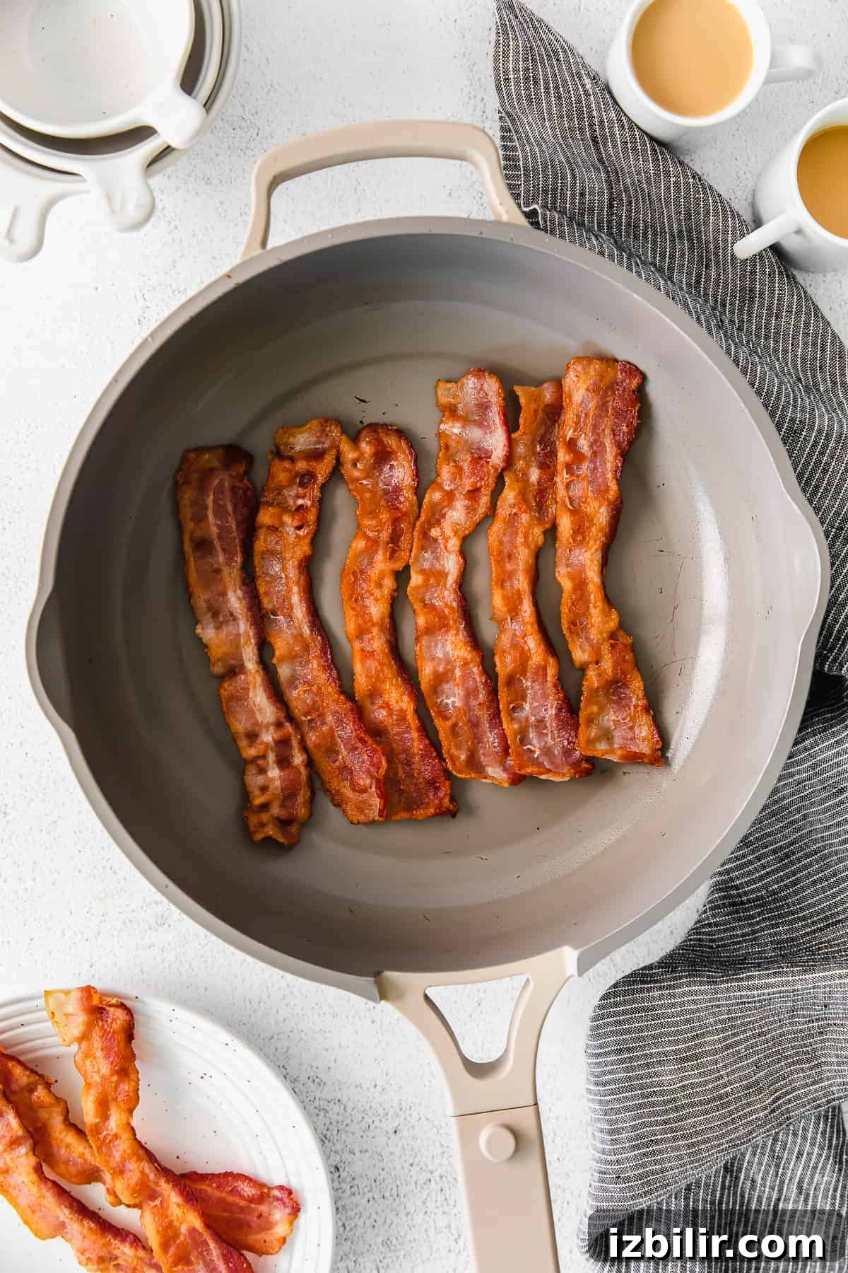 Bacon cooking in a skillet bacon in frying pan
