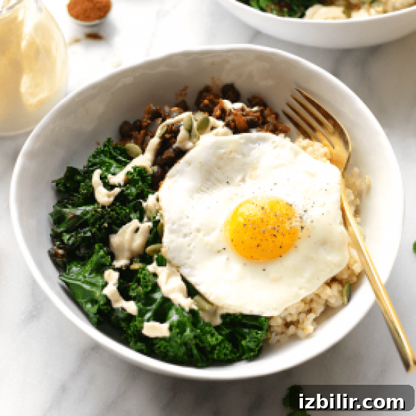 Savory Breakfast Bowls with Eggs, Avocado and Greens 6 A bowl of rice and kale with an egg on top.