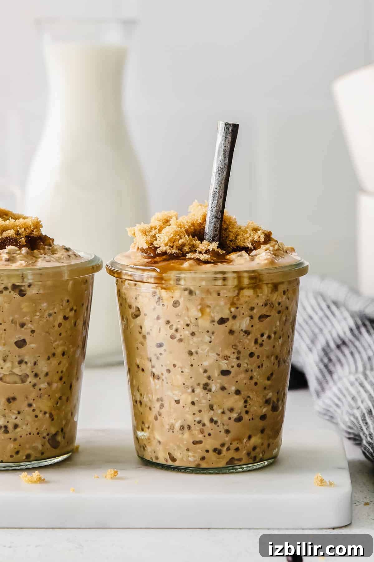 brown sugar shaken espresso overnight oats in a glass jar topped with brown sugar and chia seeds