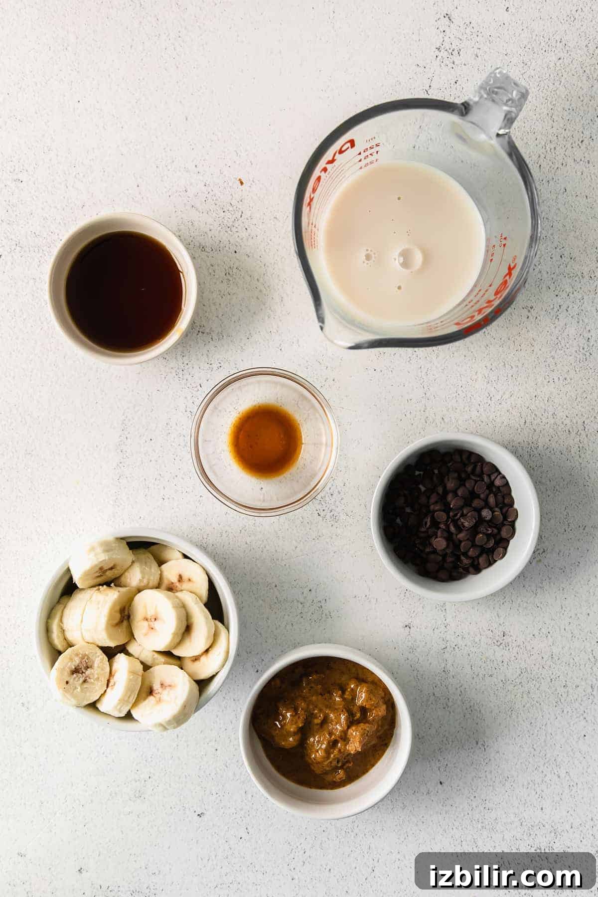 All the ingredients for a cookie dough smoothie in small bowls. 