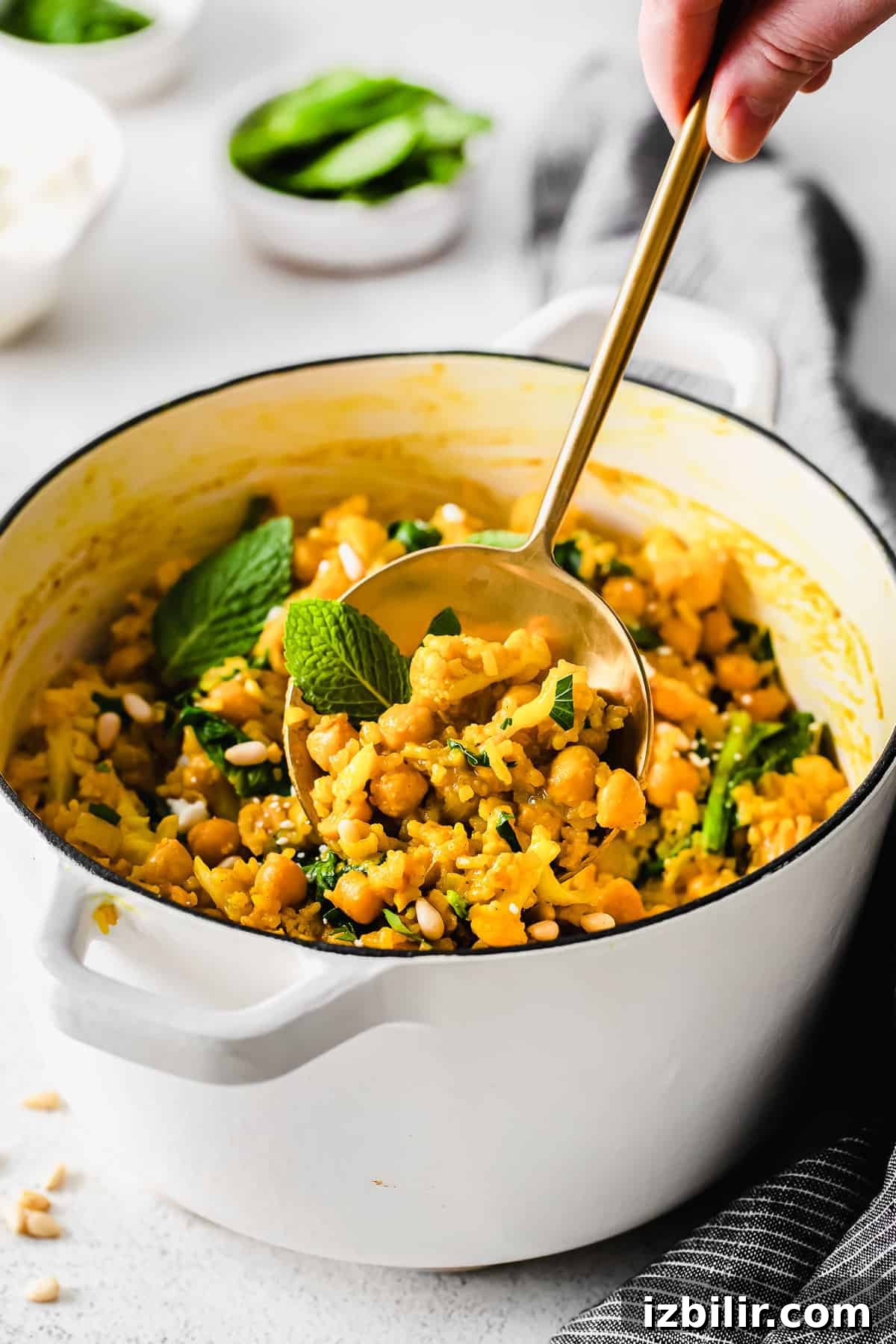One-Pot Yellow Rice with Marinated Chickpeas Recipe 7 A spoon full of yellow rice.