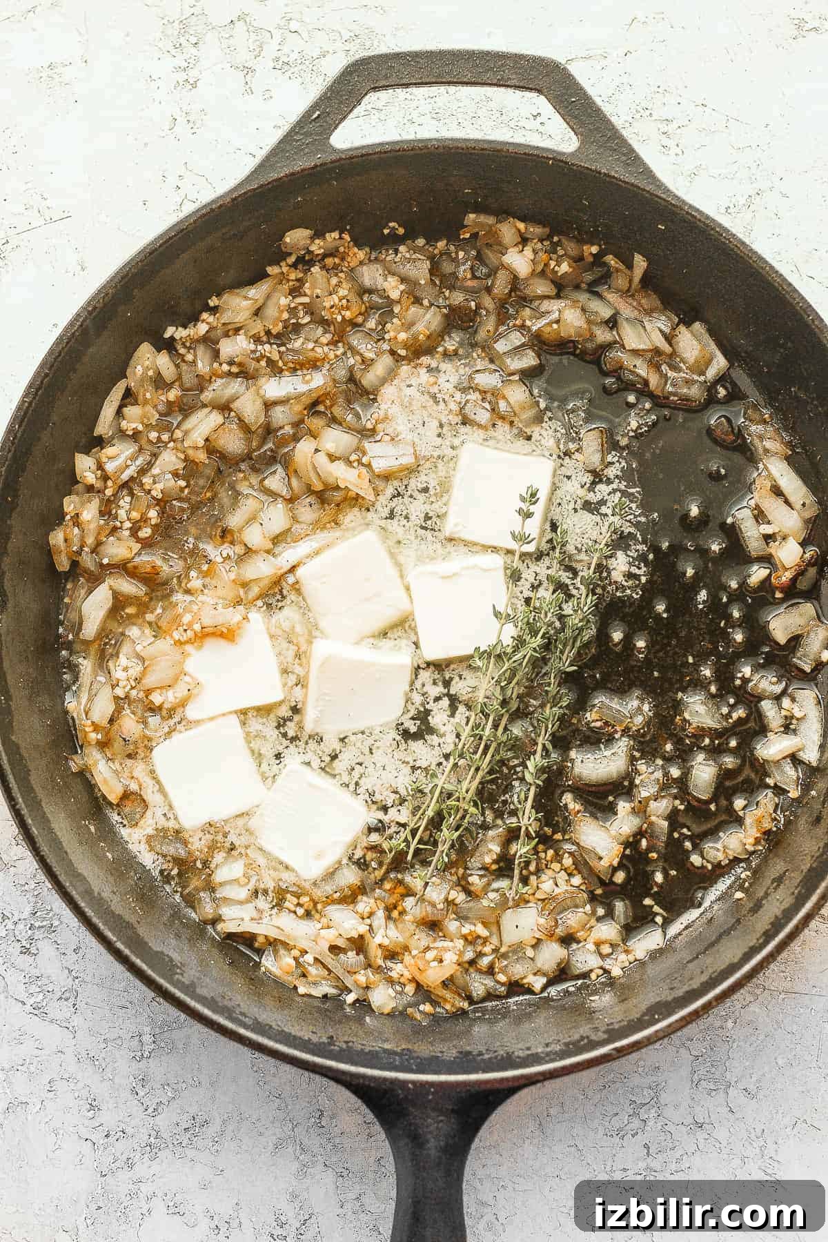 Saute onion and garlic in butter butter, onion and garlic sauteeing in a cast iron skillet