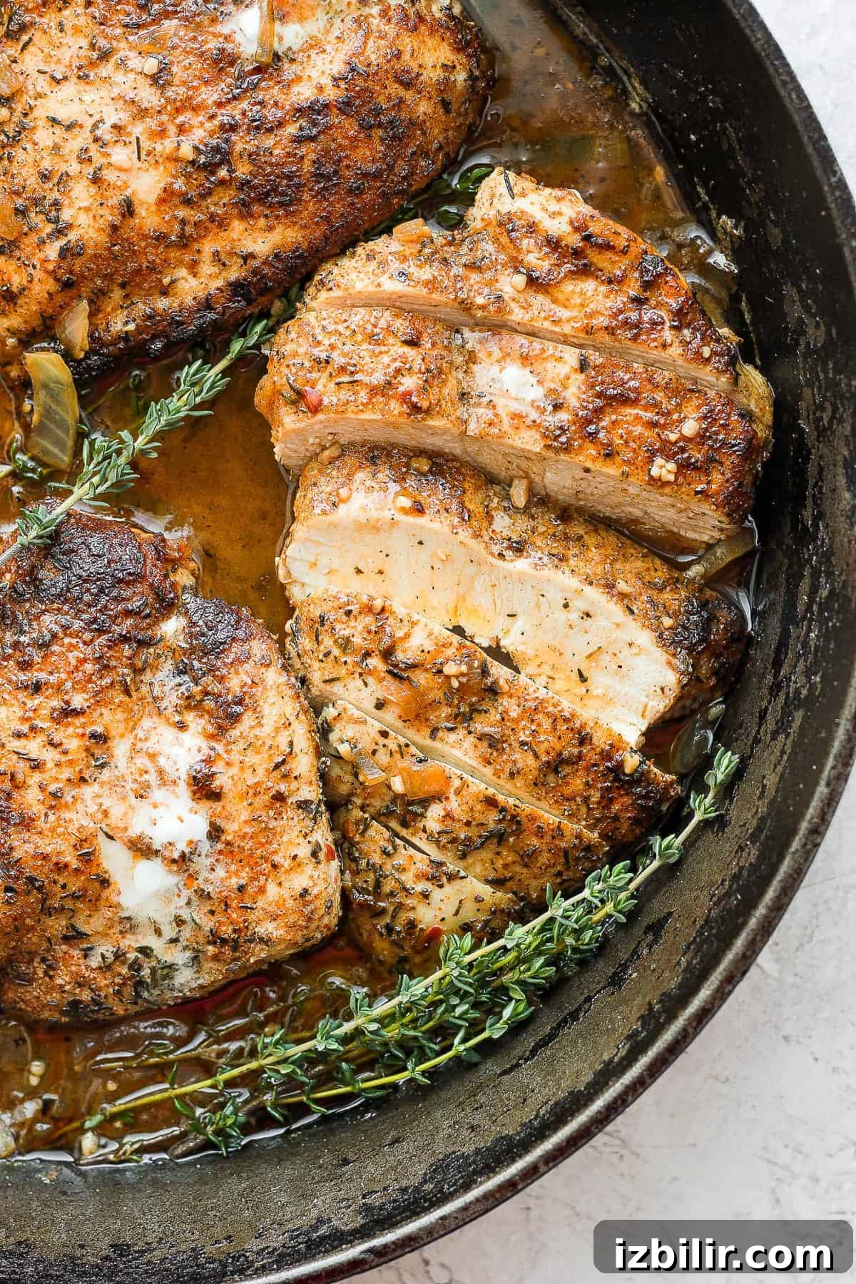 Sliced garlic butter chicken ready to serve garlic butter chicken sliced in a cast iron skillet