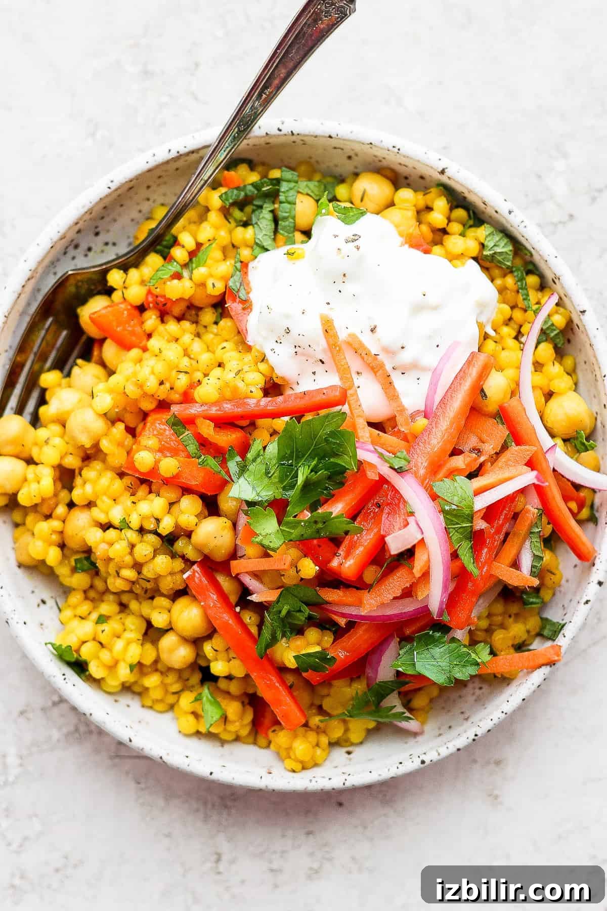 Zesty Lemon-Garlic Israeli Couscous with Whipped Feta 2 Lemon Garlic Israeli Couscous topped with whipped feta and veggies.