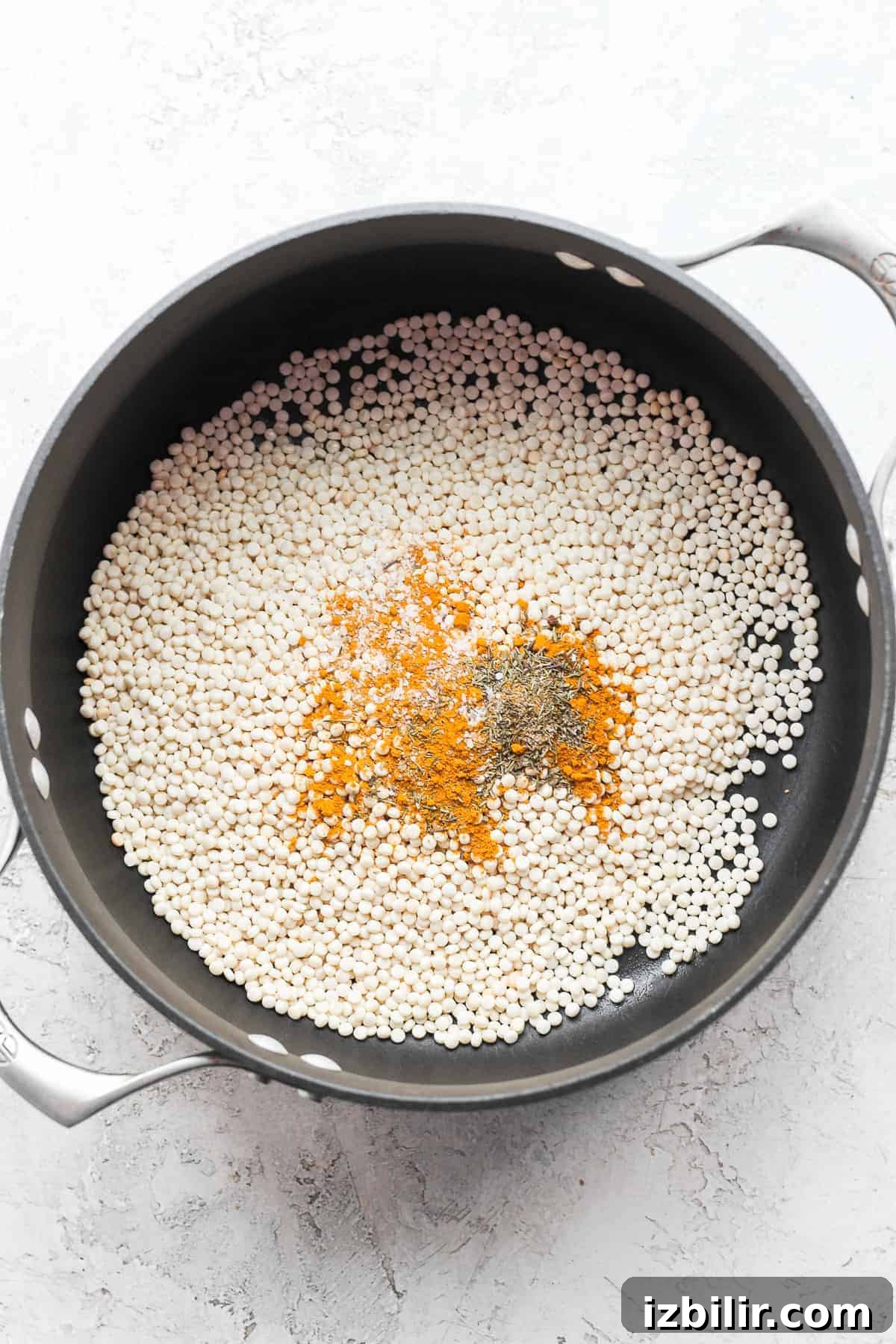 Zesty Lemon-Garlic Israeli Couscous with Whipped Feta 3 Israeli couscous and spices in a pot.