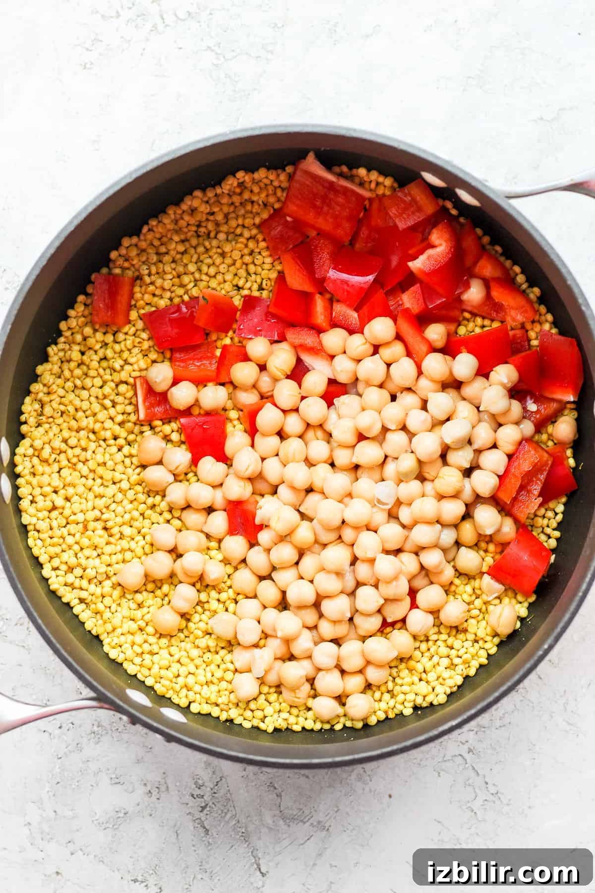 Zesty Lemon-Garlic Israeli Couscous with Whipped Feta 4 Red peppers, chickpeas, and couscous in a pot.