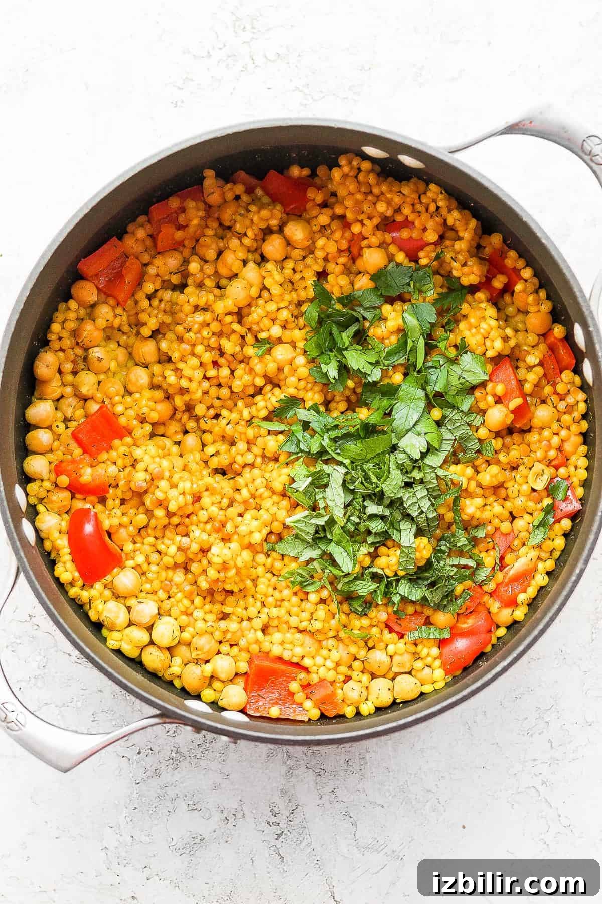 Zesty Lemon-Garlic Israeli Couscous with Whipped Feta 5 Fresh herbs on top of the cooked Israeli couscous.