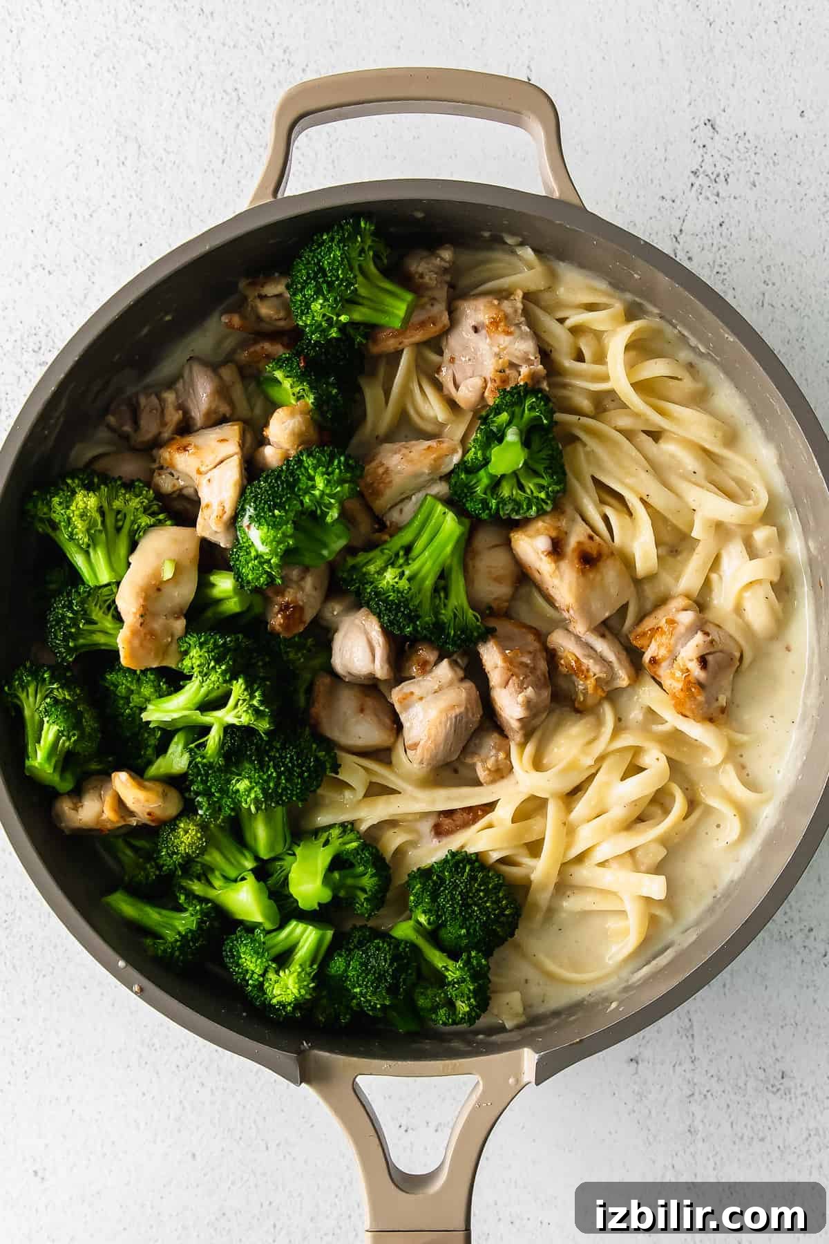 Chicken broccoli alfredo in a skillet pan. 