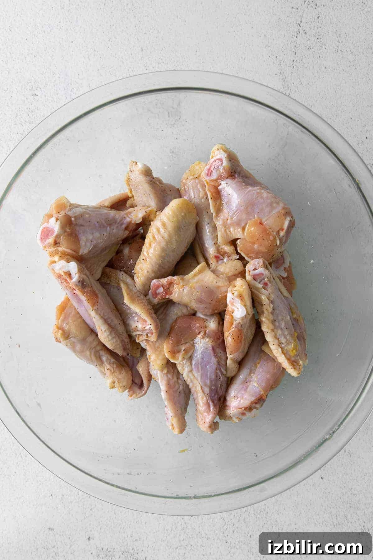Raw chicken wings in bowl.