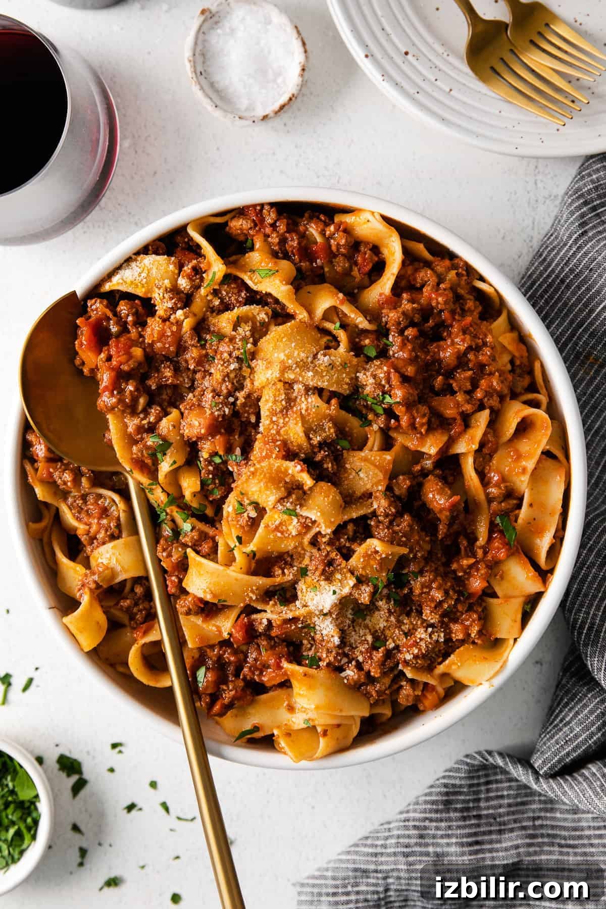 slow cooker bolognese with pasta in a dish with a spoon