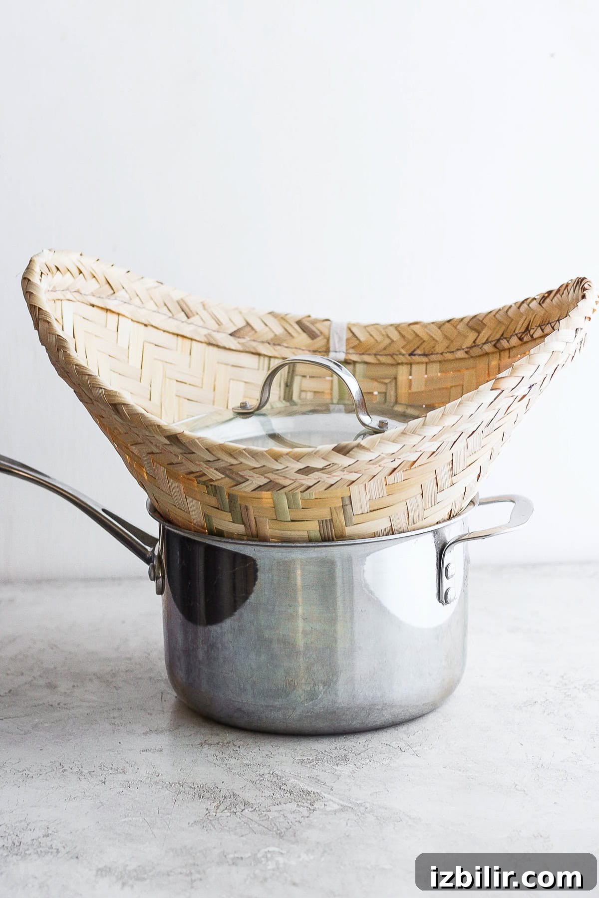 sticky rice being steamed in a pot with a bamboo basket sticky rice being steamed in a pot with a bamboo basket