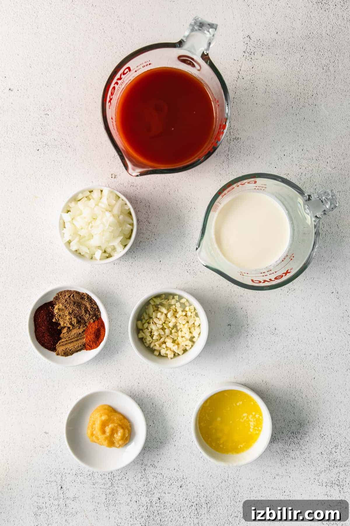 Tomato sauce, garam masala, and other ingredients for butter chicken.