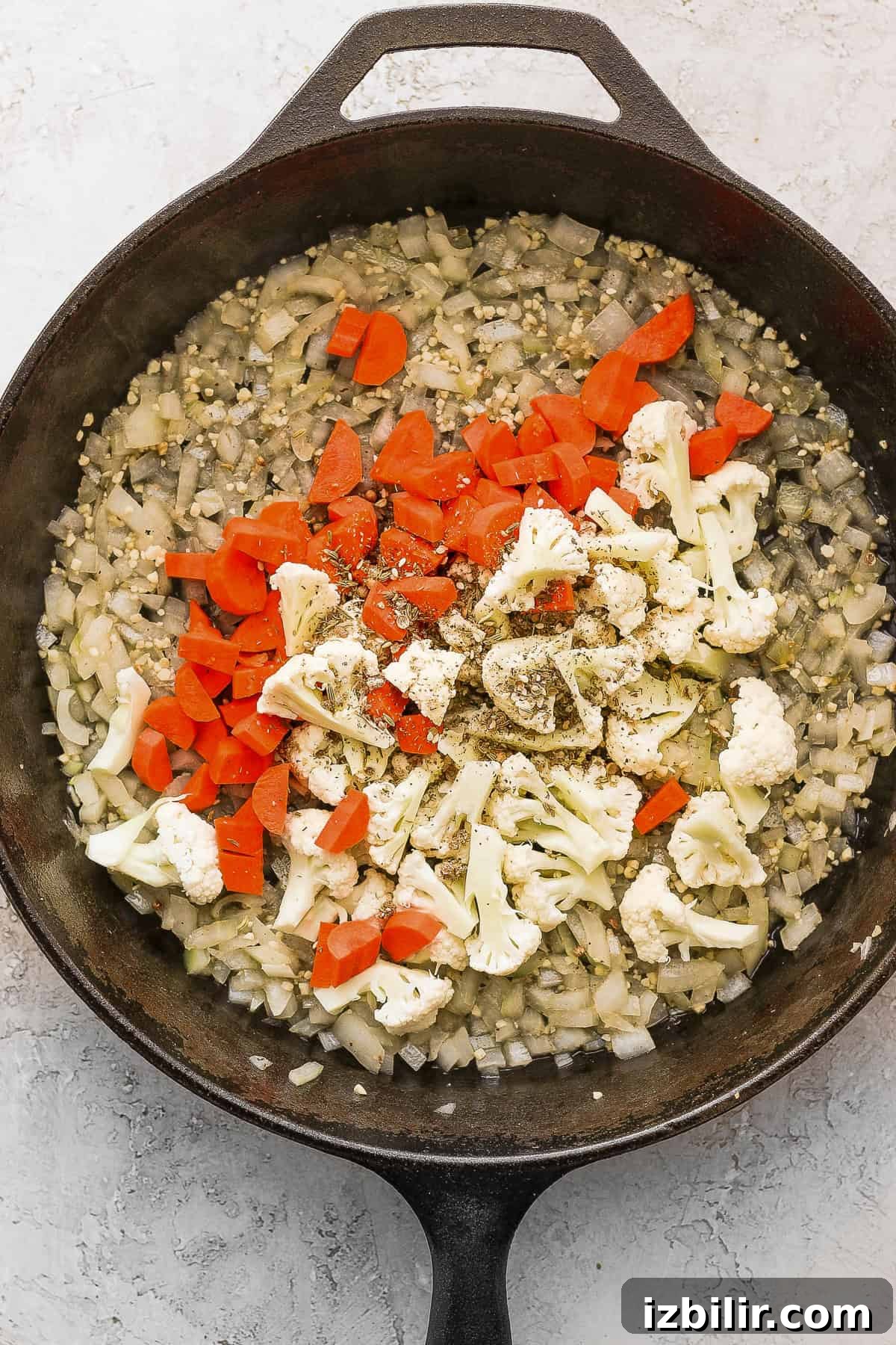 Sautéing veggies in a cast iron skillet.