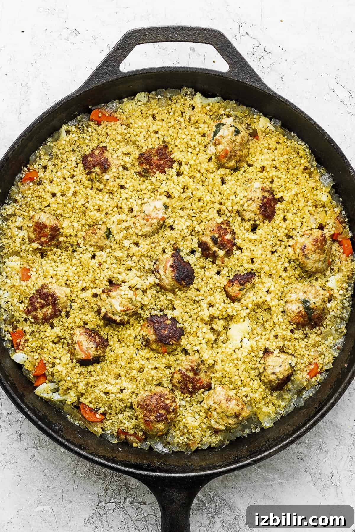 One-Pot Za'atar Meatballs and Quinoa ready to be topped with a delicious yogurt topping.