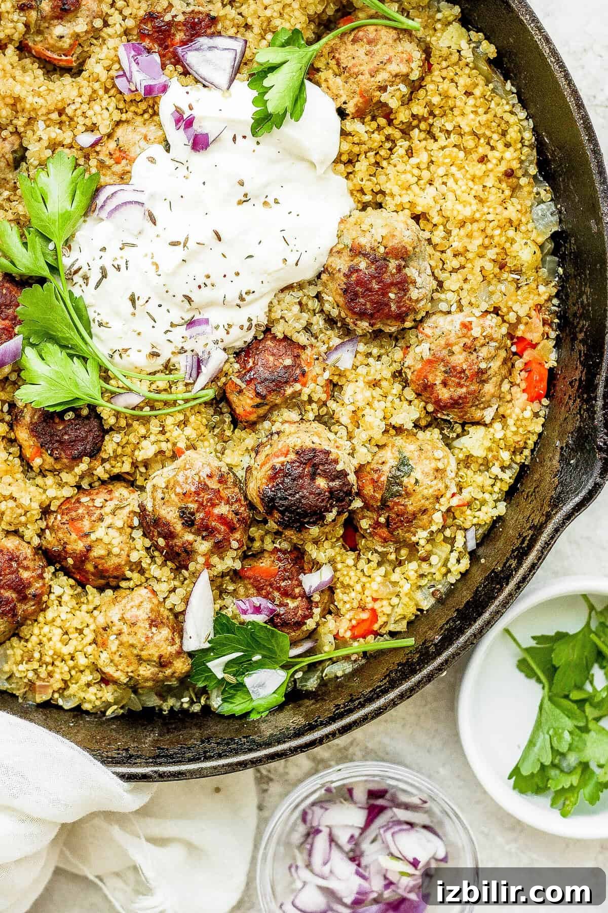 One-Pot Za'atar Meatballs and Quinoa topped with a lemon yogurt sauce.