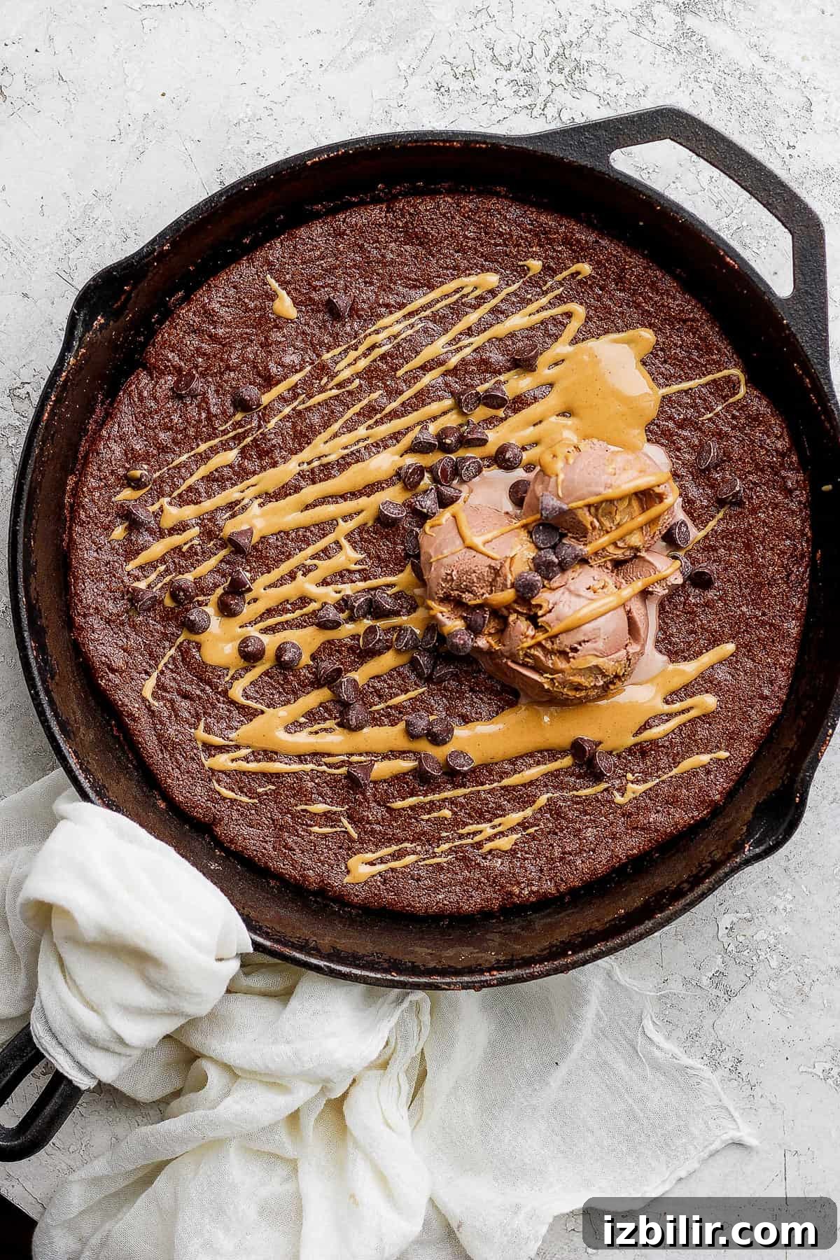 Flourless chocolate skillet cake topped with ice cream and mini chocolate chips flourless chocolate skillet cake topped with ice cream and mini chocolate chips