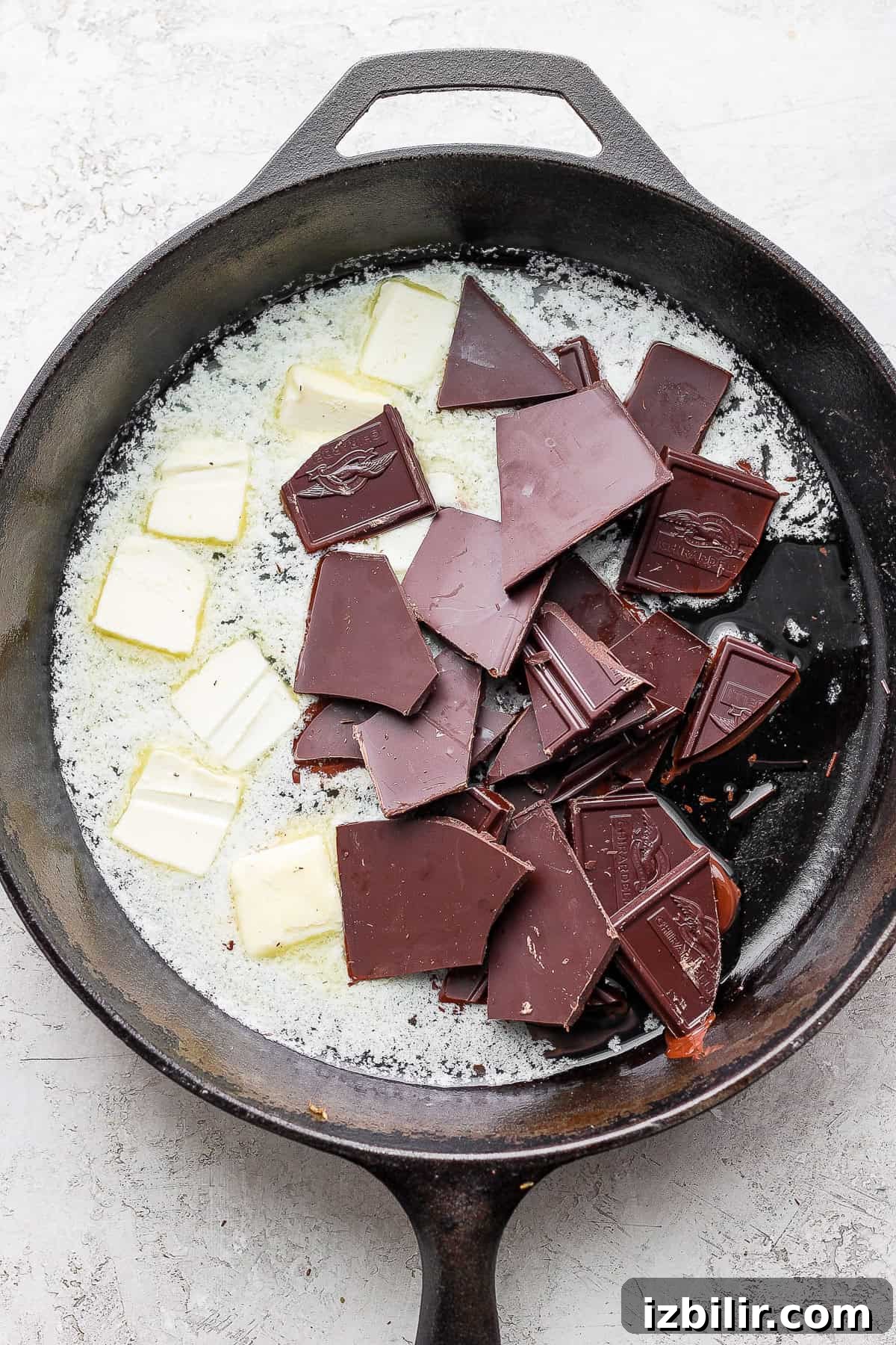 Bittersweet chocolate and butter melting in a cast iron skillet bittersweet chocolate and butter melting in a cast iron skillet