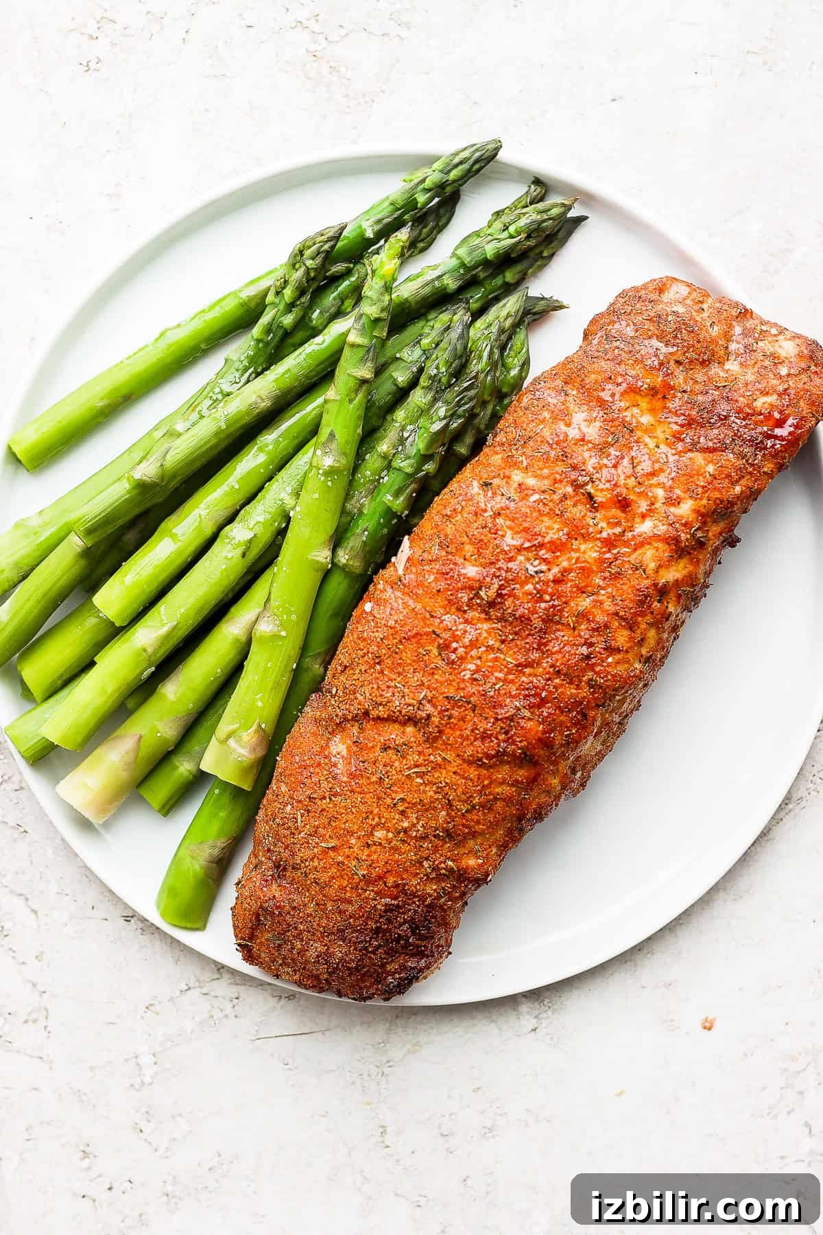Crispy Air Fryer Pork Tenderloin with Garlic Herb Rub 7 air fryer pork tenderloin on a plate with asparagus