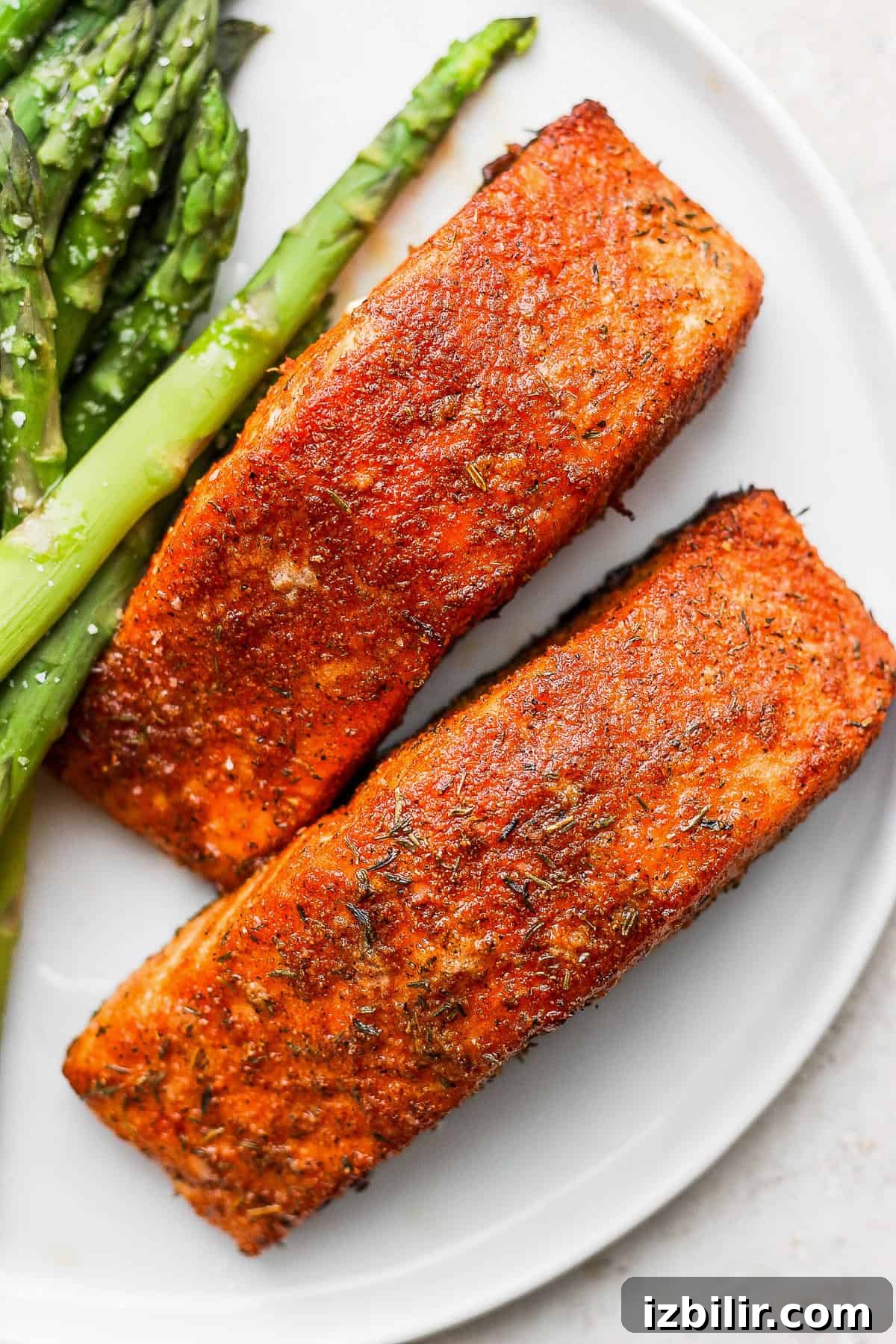 Zesty Salmon Seasoning Recipe for Grilling and Baking 6 salmon filets on a plate with asparagus