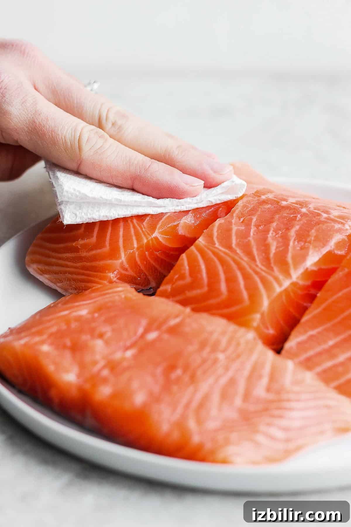 Crispy Air Fryer Salmon with Garlic and Lemon 3 Patting raw salmon with paper towel to dry