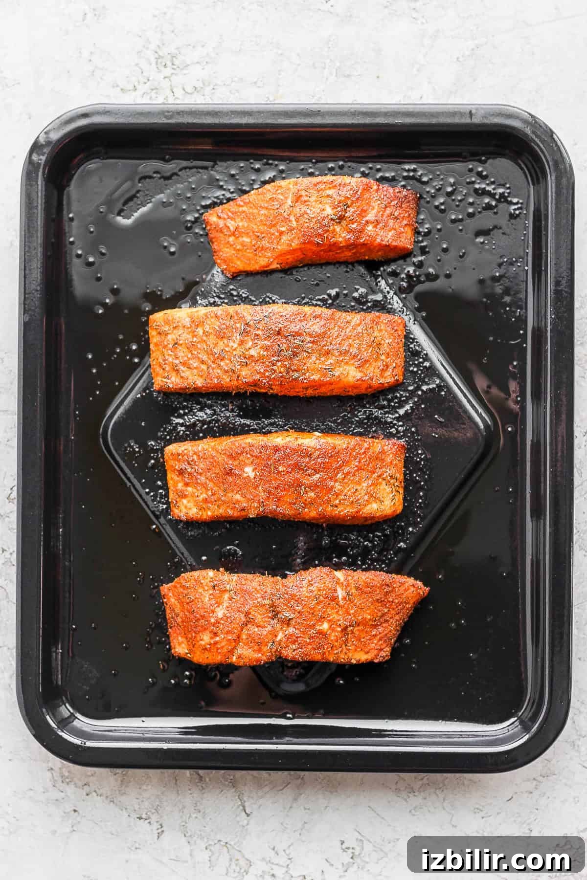 Cook skin-side down; no flip needed Salmon skin-side down on air fryer basket