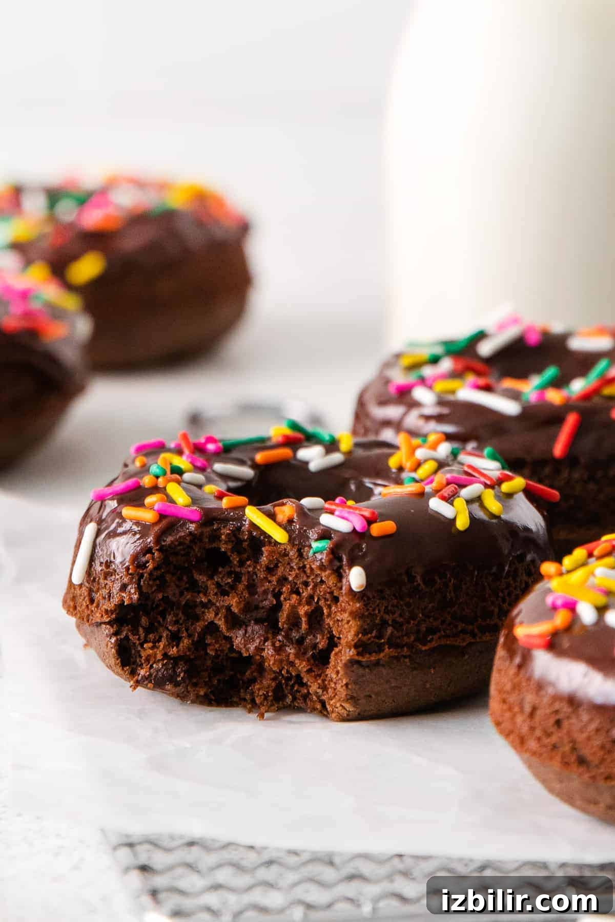 Chocolate baked donut with a bite taken bite taken out of donut