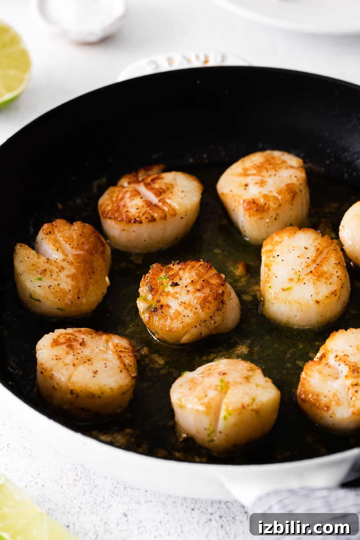 Cooked scallops in a cast iron.