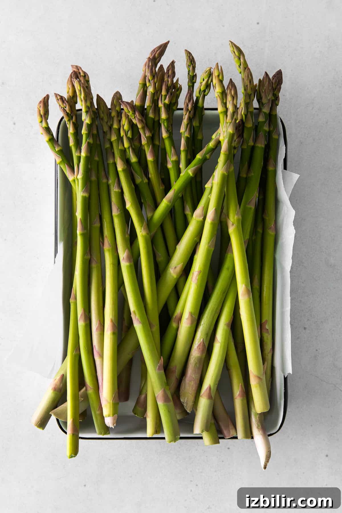 Crispy Air Fryer Asparagus with Lemon and Garlic 3 Fresh asparagus in a tray.