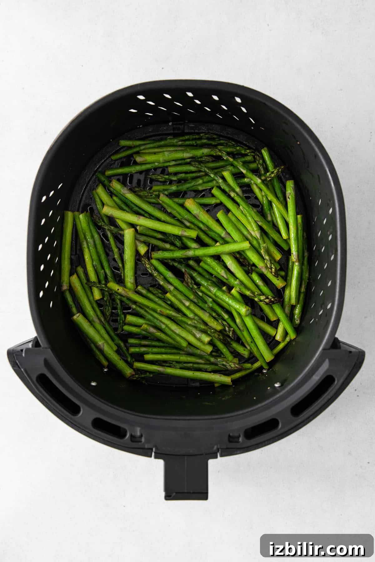 Crispy Air Fryer Asparagus with Lemon and Garlic 5 Asparagus in the air fryer.