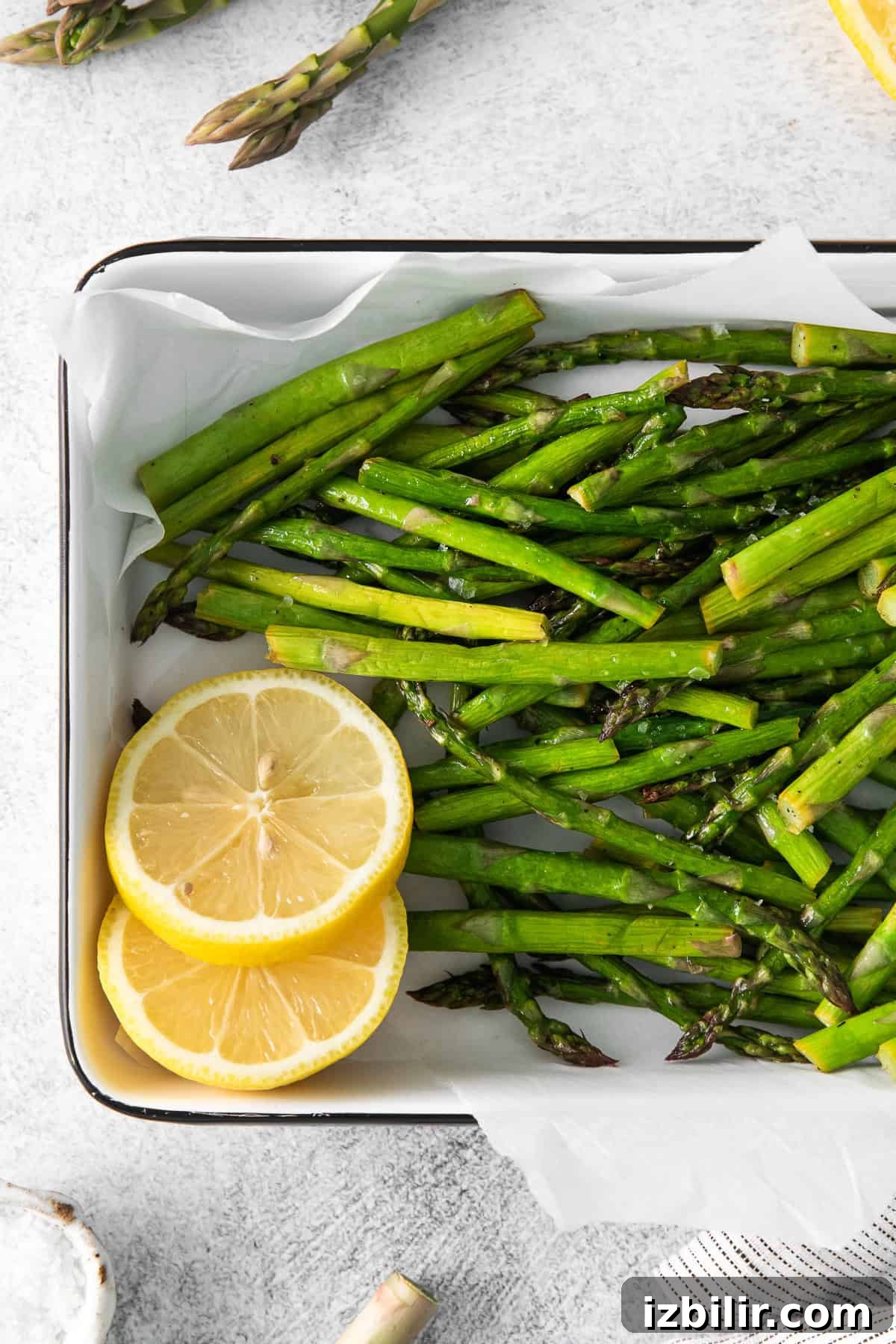 Crispy Air Fryer Asparagus with Lemon and Garlic 6 Cooked asparagus on a plate.