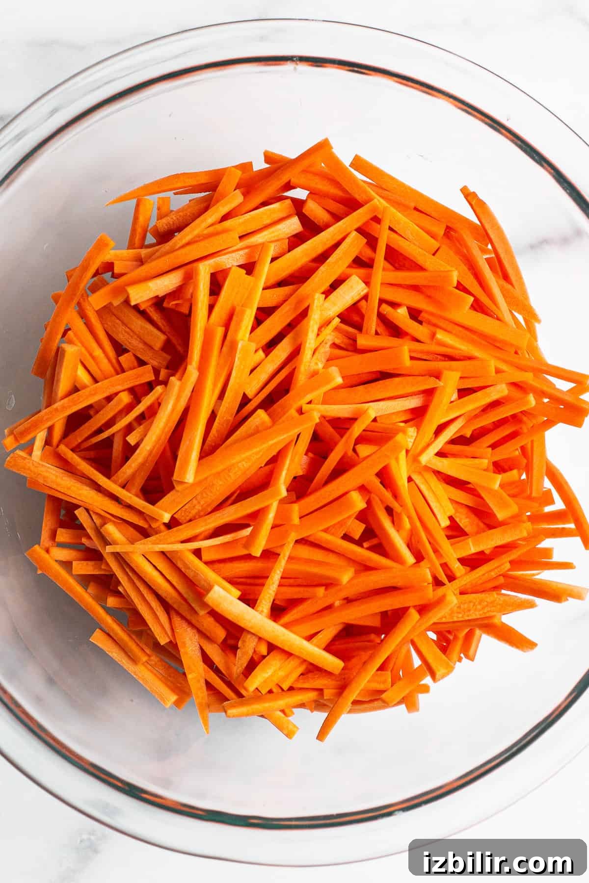 French Carrot Salad with Honey-Mustard Dressing Recipe 3 Julienned carrots in a bowl.